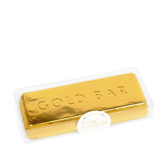 Milk solid chocolate gold bar, in the shape of a gold ingot, wrapped in in gold foil, with the words "GOLD BAR" engraved into the chocolate 